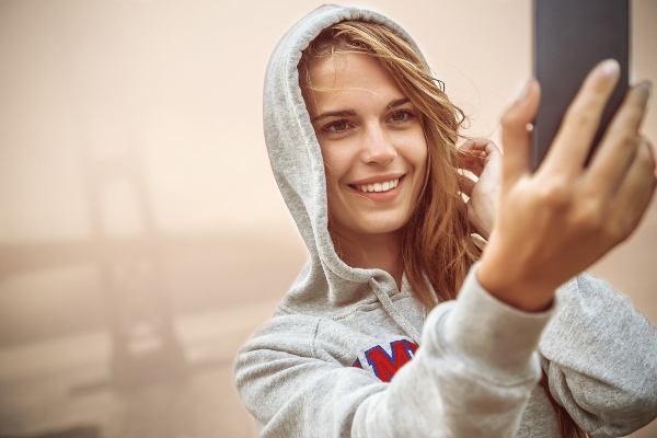 Girl taking a Hoodie Selfie