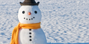 cute snowman on snowy field