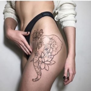 elephant and lotuses tattoo on the thigh