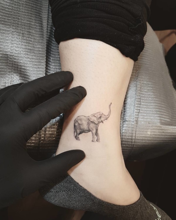 small elephant tattoo trunk up on the leg