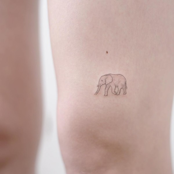 tiny elephant tattoo on the leg