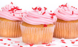 Pink Valentines Day cupcakes with sprinkles, shallow depth